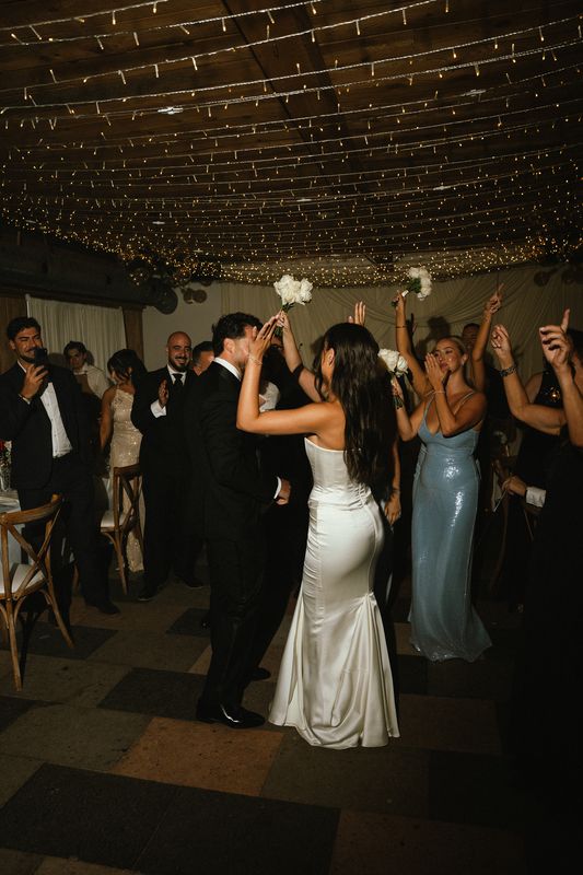 Bride and groom dancing as guests cheer around them, Montreal wedding photography
